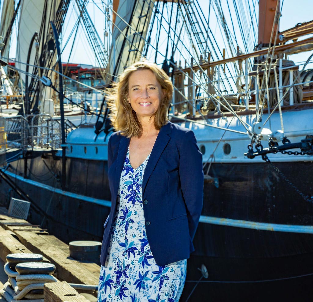 Portrait shot of Dr. Christina Brophy, standing in from of Star of India.